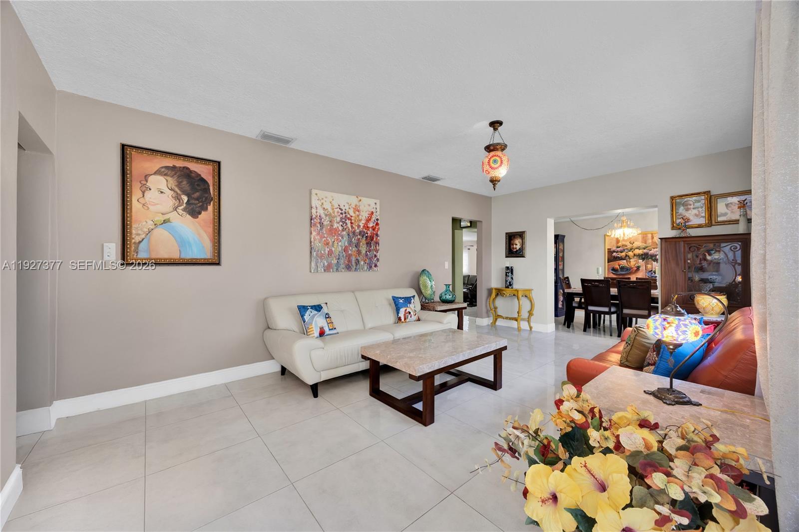4110 West 7th Lane Hialeah, FL 33012 - Photo 4 of 22 a living room with furniture and a chandelier