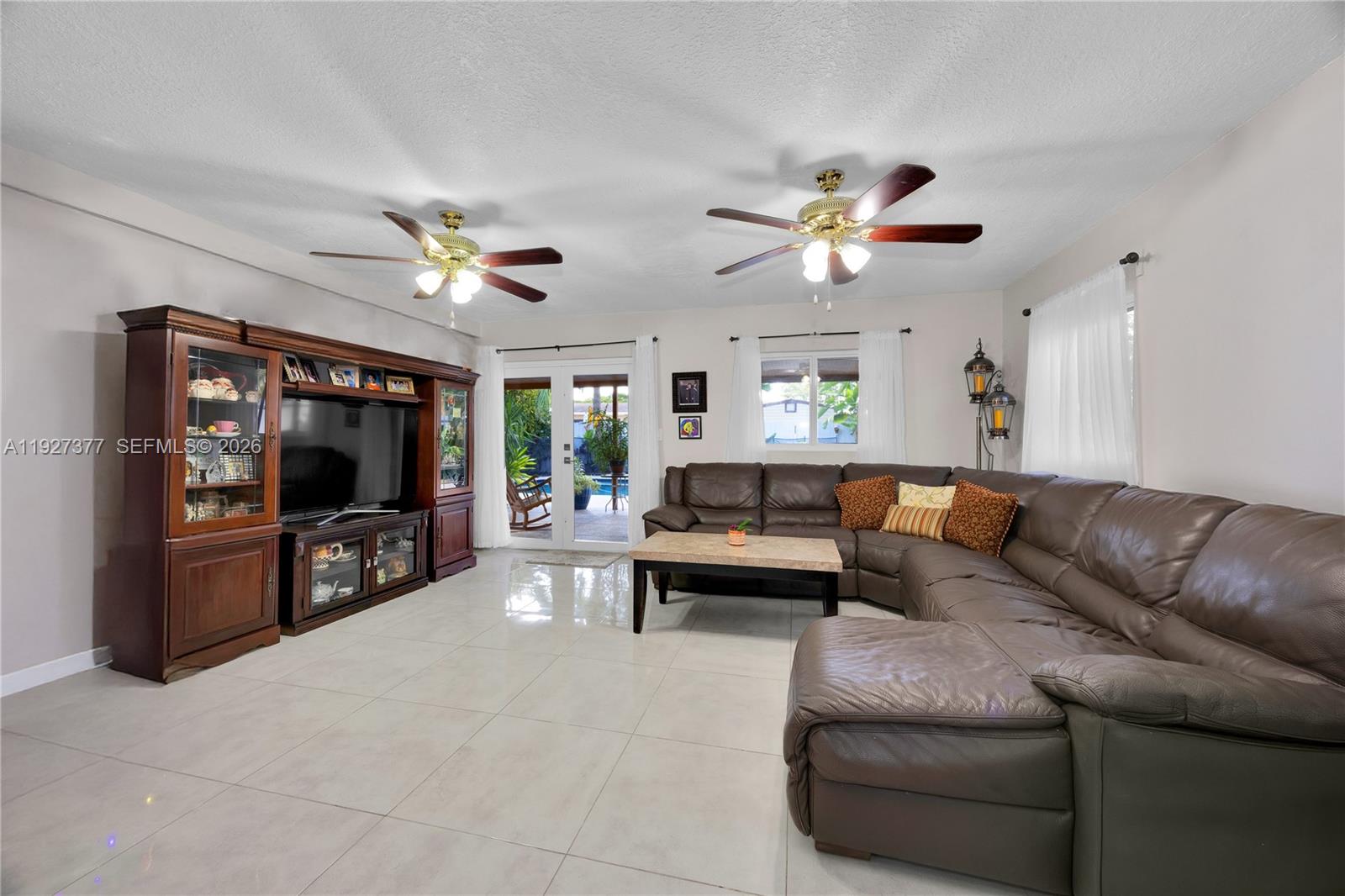4110 West 7th Lane Hialeah, FL 33012 - Photo 6 of 22 a living room with furniture and a flat screen tv