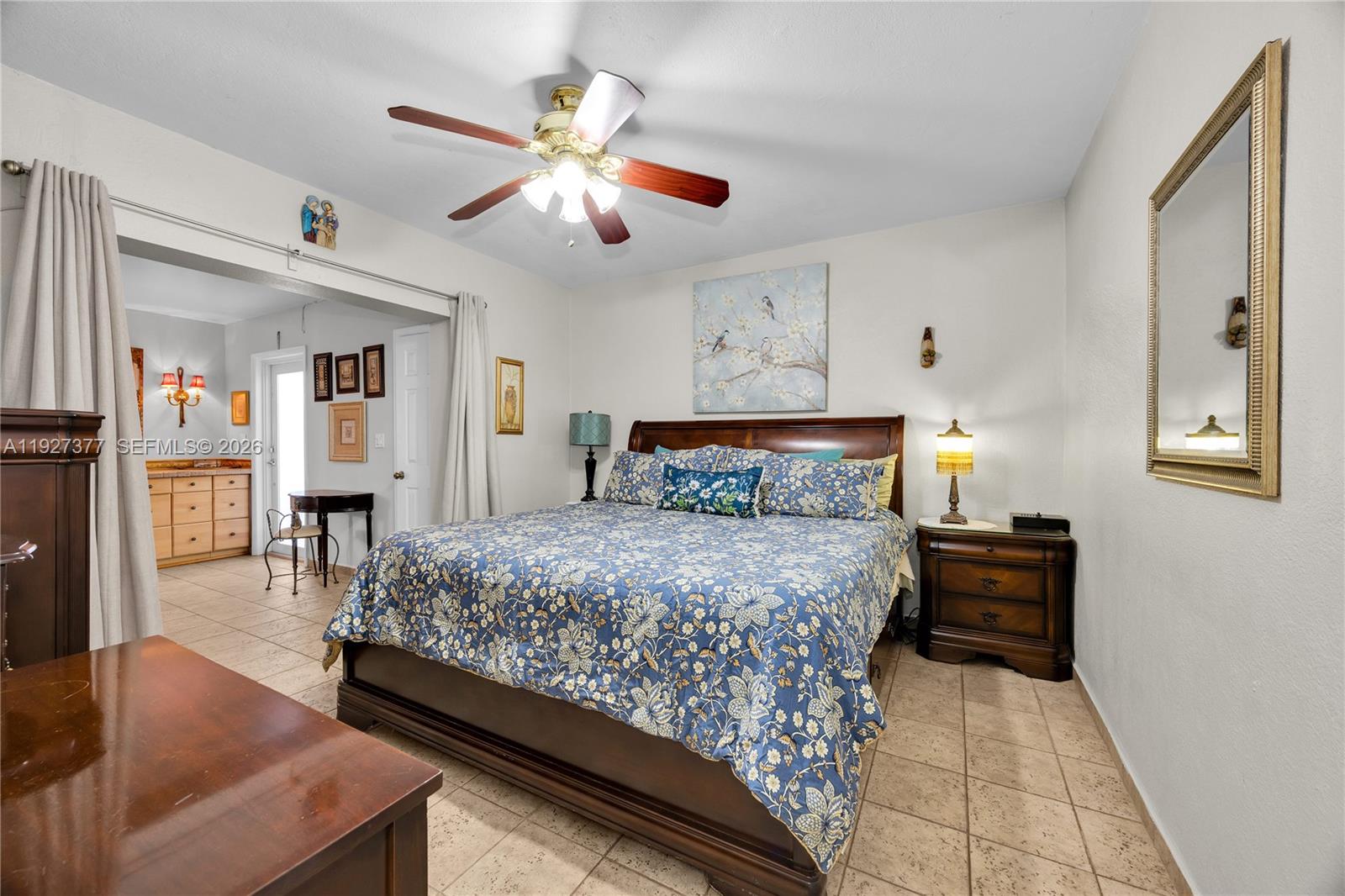 4110 West 7th Lane Hialeah, FL 33012 - Photo 7 of 22 a bedroom with a bed and a chandelier