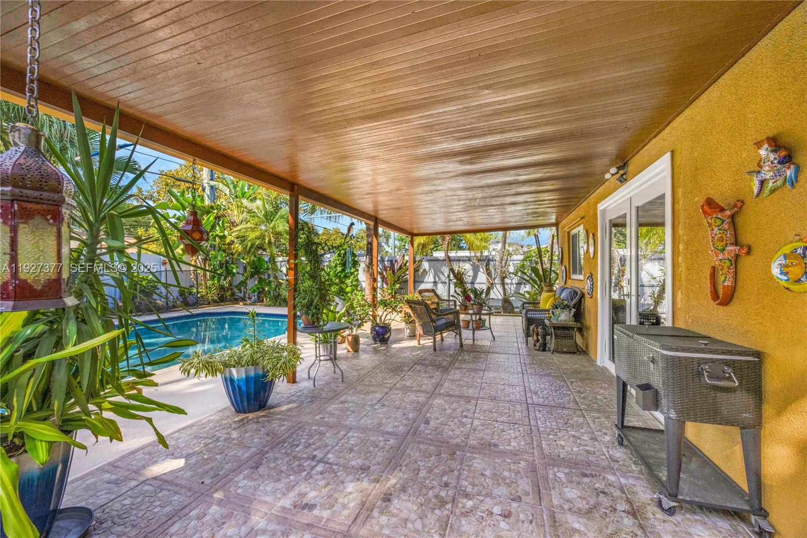 4110 West 7th Lane Hialeah, FL 33012 - Photo 10 of 24 a view of a porch with chairs and backyard