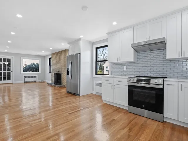 a kitchen with stainless steel appliances granite countertop a stove and a refrigerator