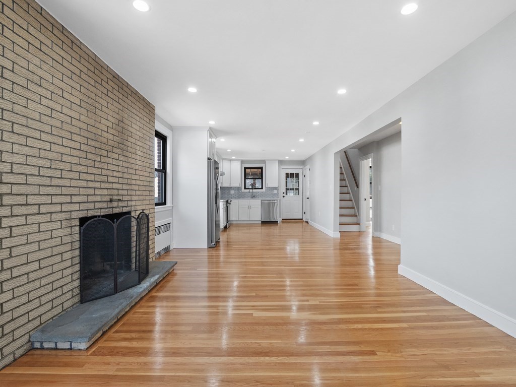 48 Albert Street Waltham, MA 02453 - Photo 12 of 37 a big room with wooden floor and fire place