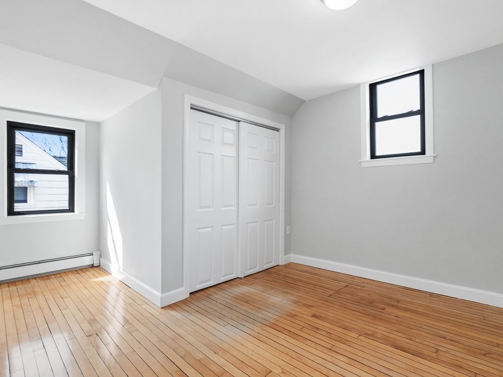 48 Albert Street Waltham, MA 02453 - Photo 20 of 37 an empty room with wooden floor and windows