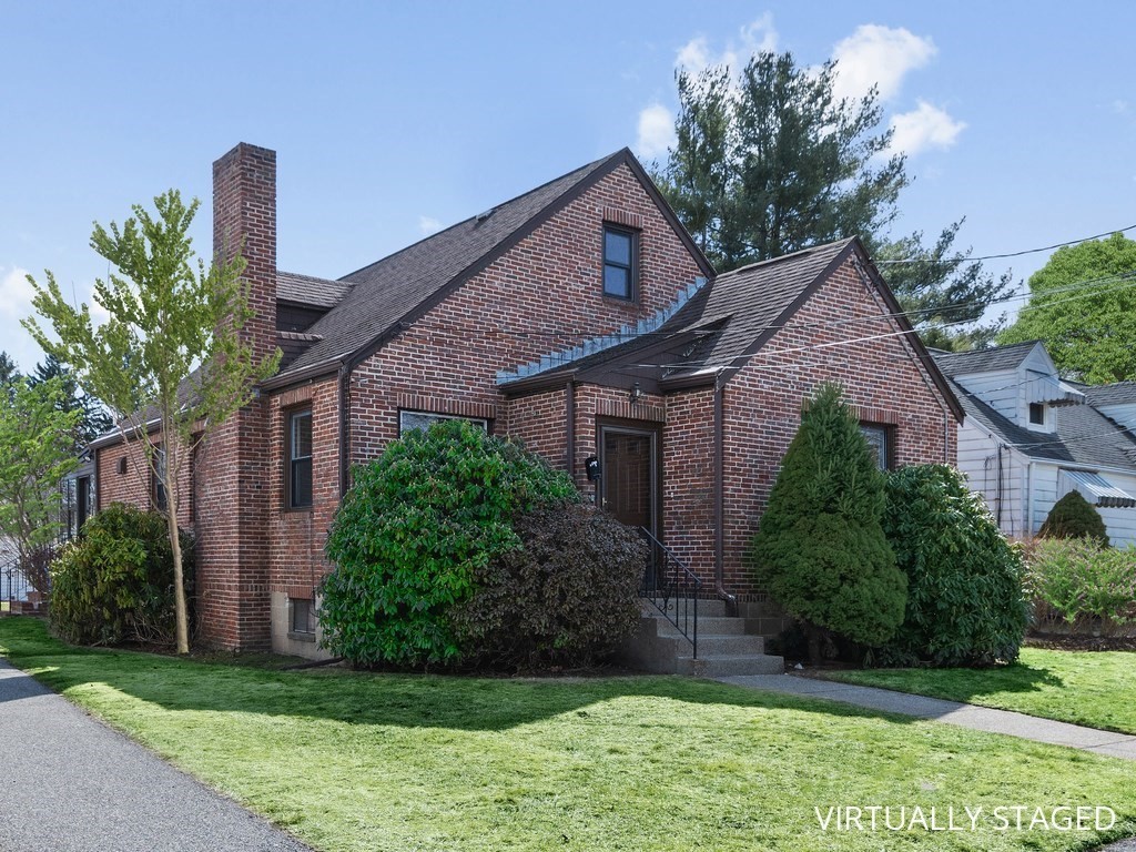 48 Albert Street Waltham, MA 02453 - Photo 2 of 37 a front view of a house with a garden