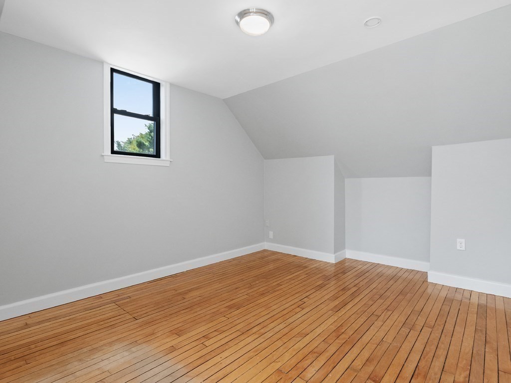 48 Albert Street Waltham, MA 02453 - Photo 21 of 37 an empty room with wooden floor and windows