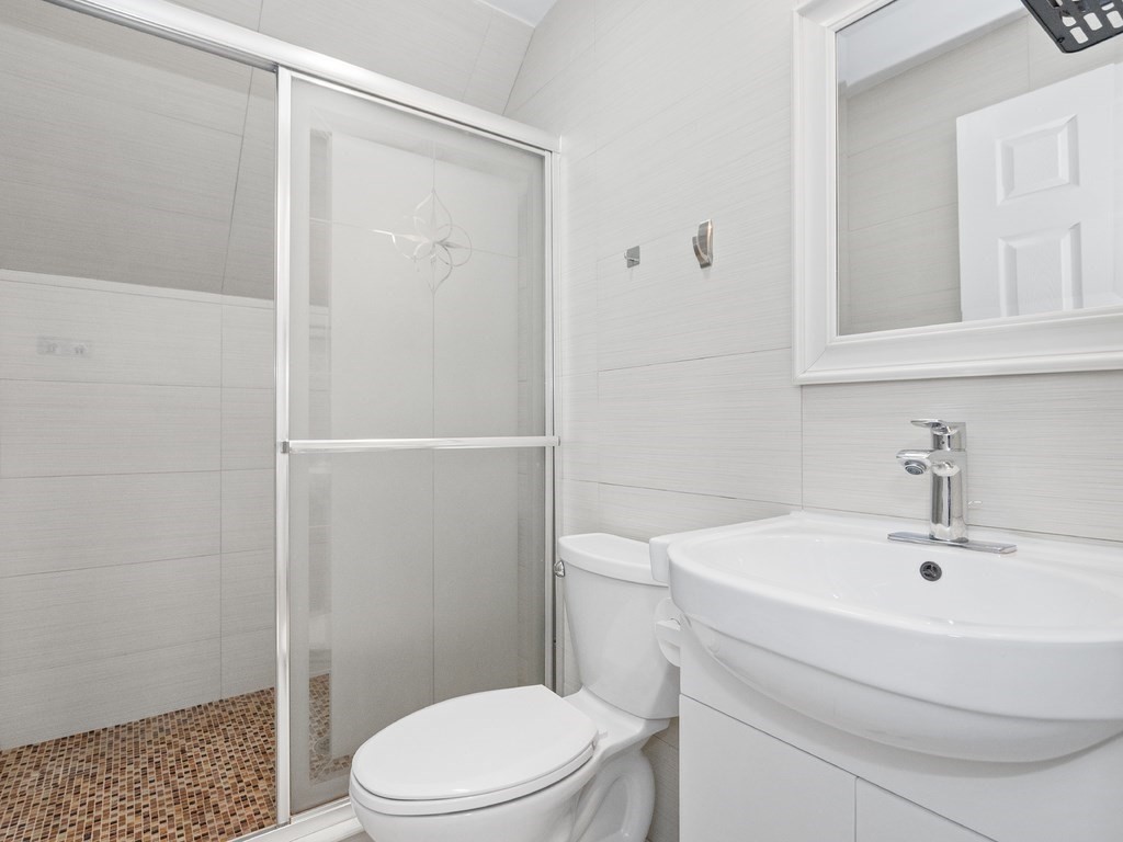 48 Albert Street Waltham, MA 02453 - Photo 24 of 37 a white toilet sitting next to a bathroom sink