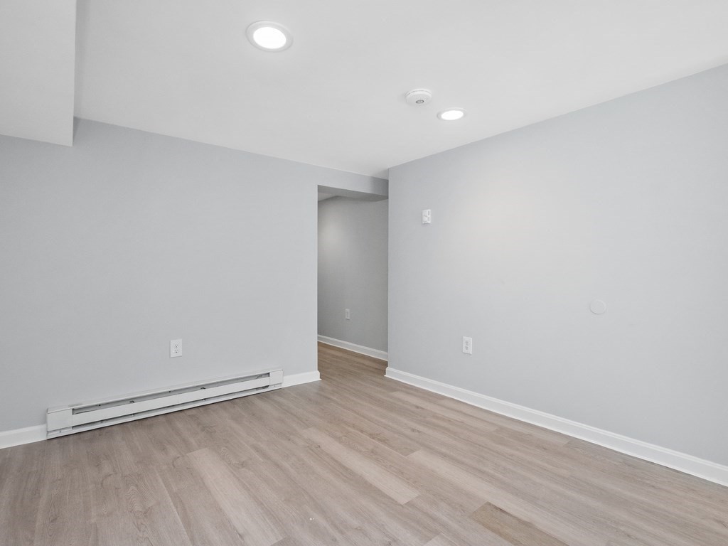 48 Albert Street Waltham, MA 02453 - Photo 26 of 37 a view of an empty room with wooden floor