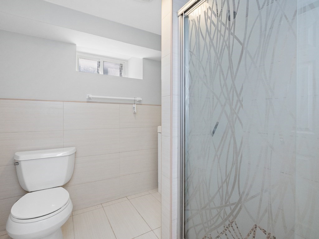 48 Albert Street Waltham, MA 02453 - Photo 29 of 37 a white toilet sitting next to a shower
