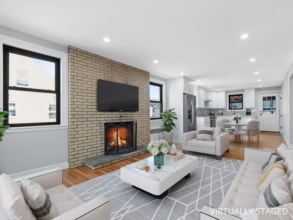 48 Albert Street Waltham, MA 02453 - Photo 5 of 37 a living room with furniture flat screen tv and a fireplace