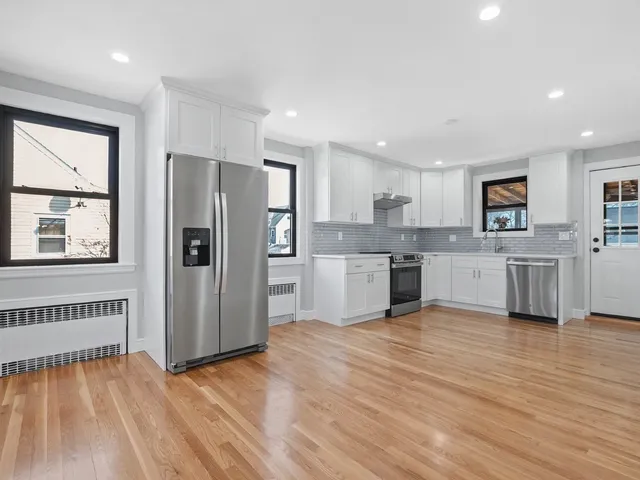 a kitchen with stainless steel appliances a refrigerator sink and cabinets