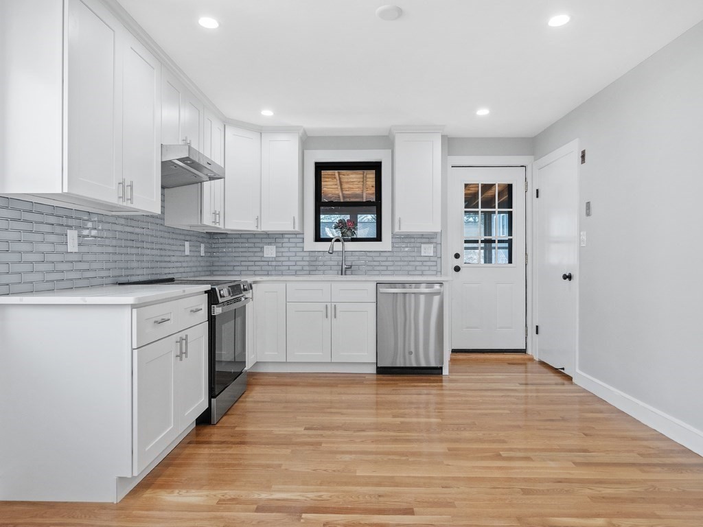 48 Albert Street Waltham, MA 02453 - Photo 8 of 37 a large kitchen with stainless steel appliances granite countertop a sink and cabinets