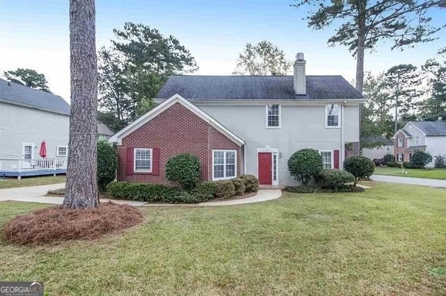a front view of a house with garden