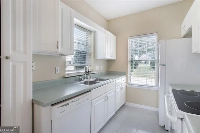 a kitchen with a sink cabinets and window