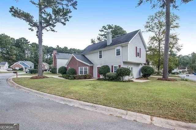 a front view of a house with garden
