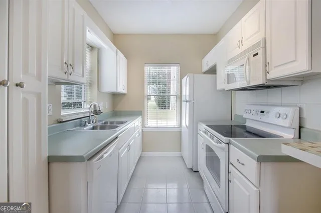 a kitchen with a sink stove and cabinets