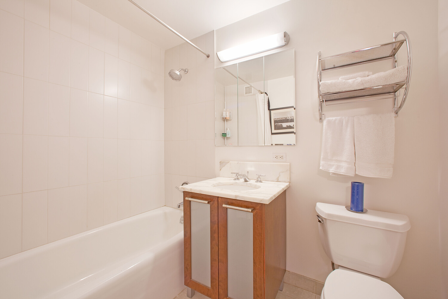 121 East 23rd Street, Unit 5F Manhattan, NY 10010 - Photo 4 of 6 a bathroom with a sink toilet and shower