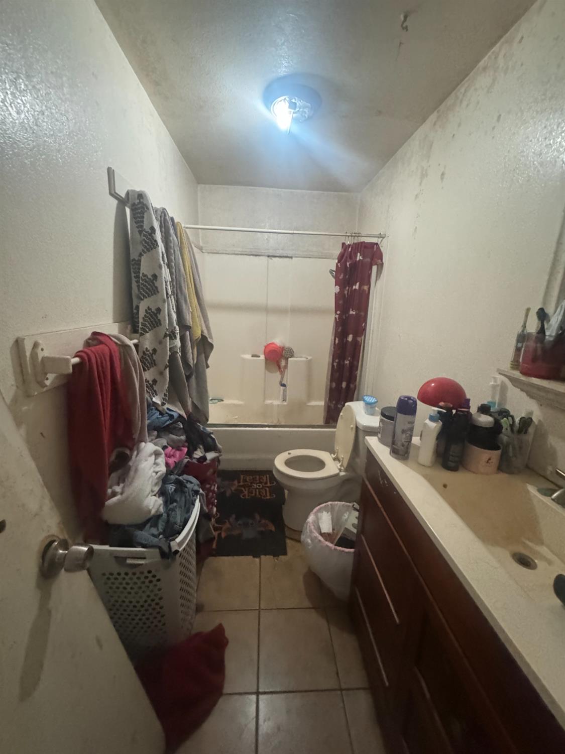 2249 East Vine Street Stockton, CA 95205 - Photo 5 of 8 a bathroom with a sink mirror and toilet