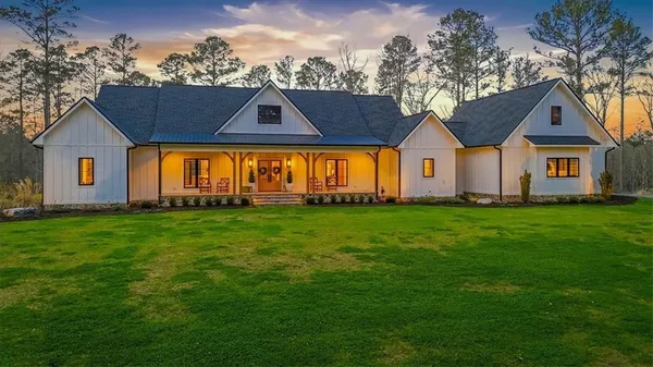 a front view of house with yard and green space