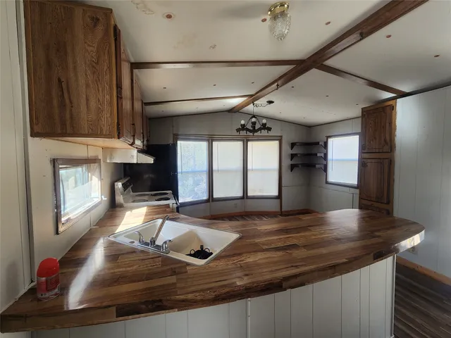a living room with kitchen island granite countertop furniture and a fireplace