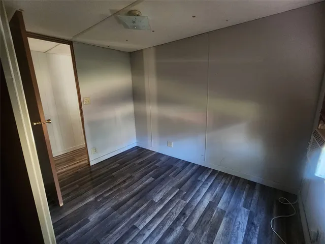 an empty room with wooden floor