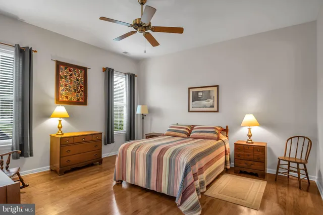 a bedroom with a bed a couch and a chandelier