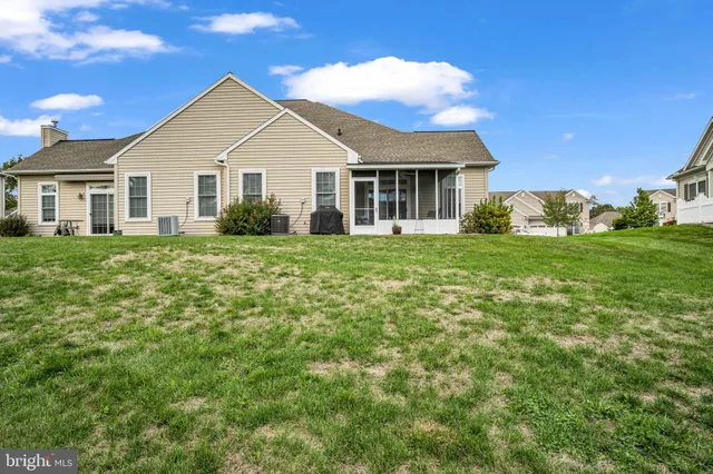 a view of a house with a big yard and large trees