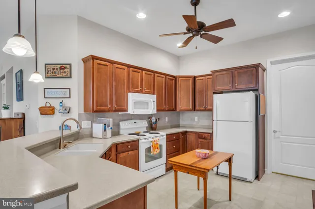 a kitchen with stainless steel appliances granite countertop a sink refrigerator and cabinets