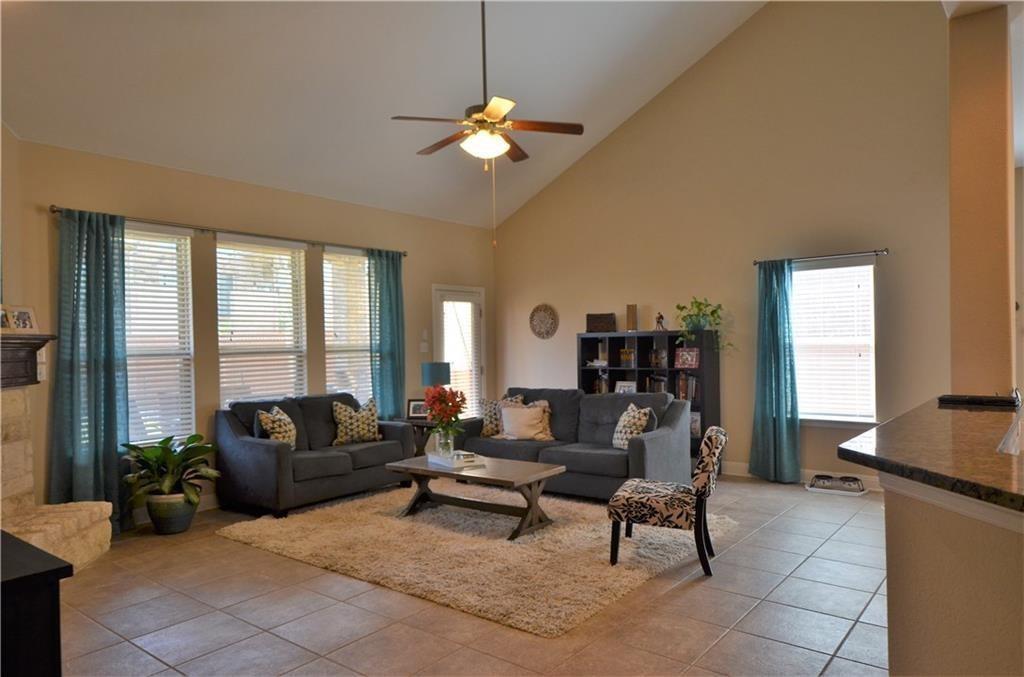 5629 Rio Chama Cove Austin, TX 78738 - Photo 3 of 34 The living area is illuminated by abundant natural light and features a high vaulted ceiling, creating an open and airy atmosphere.