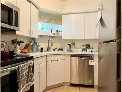 a kitchen with a sink cabinets and window