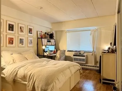 a bedroom with a bed and a flat tv screen