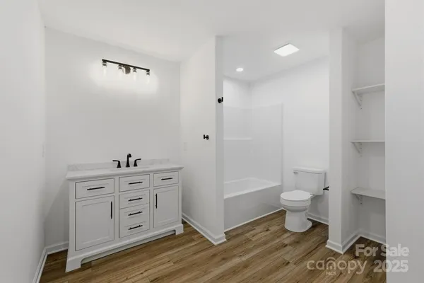 a bathroom with a toilet a sink and a bathtub