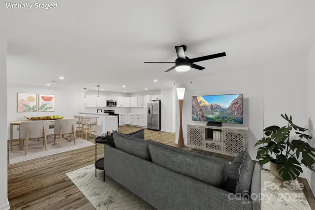 a living room with furniture and a ceiling fan