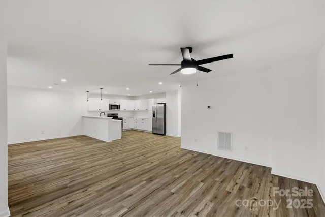 a view of an empty room with a ceiling fan