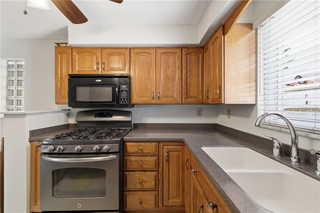 1368 Cathell Road Pittsburgh, PA 15236 - Photo 12 of 28 a kitchen with granite countertop stainless steel appliances a stove sink and microwave
