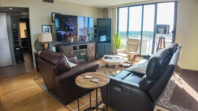 a living room with furniture and a floor to ceiling window