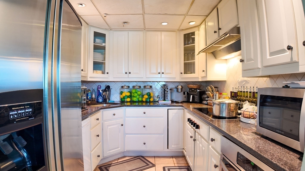 51 Broad Reach, Unit M65A Weymouth, MA 02191 - Photo 6 of 16 a kitchen with white cabinets and appliances