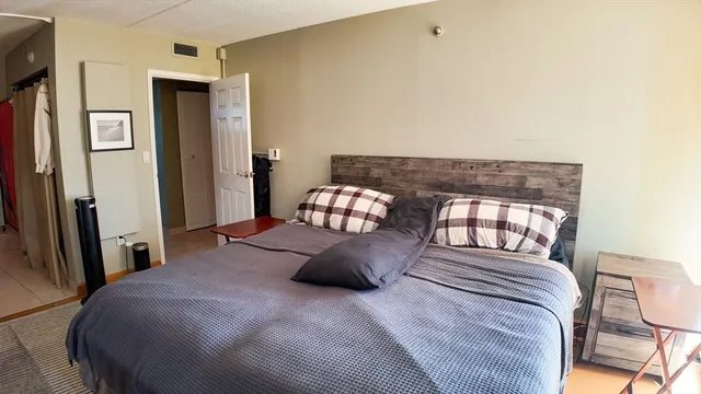 a bedroom with a bed and a chair