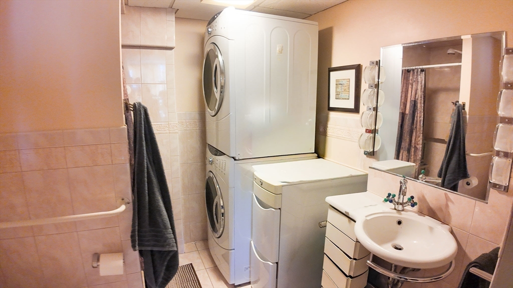 51 Broad Reach, Unit M65A Weymouth, MA 02191 - Photo 8 of 16 a bathroom with a sink a toilet and a mirror