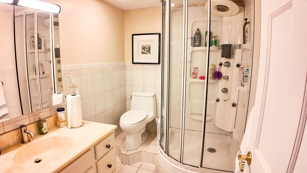 51 Broad Reach, Unit M65A Weymouth, MA 02191 - Photo 10 of 16 a bathroom with a sink a toilet and shower