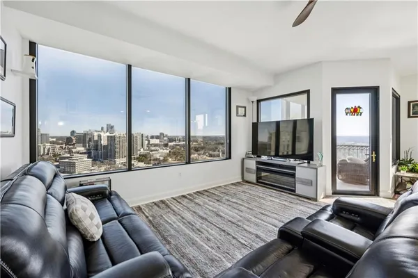 a living room with furniture and a floor to ceiling window