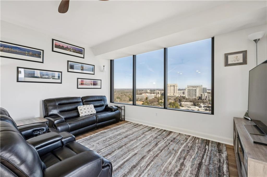 2828 Peachtree Road Northwest, Unit 2502 Atlanta, GA 30305 - Photo 12 of 38 a living room with furniture and a floor to ceiling window