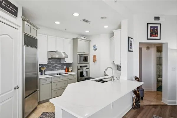 a kitchen with a sink a stove and cabinets