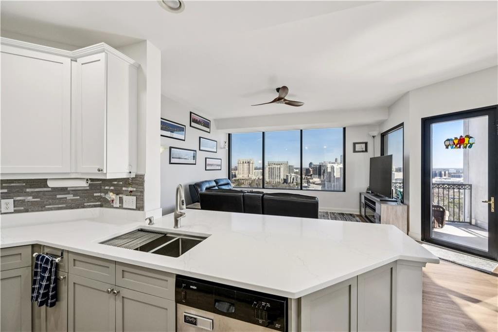 2828 Peachtree Road Northwest, Unit 2502 Atlanta, GA 30305 - Photo 15 of 38 a kitchen with a sink a stove and cabinets
