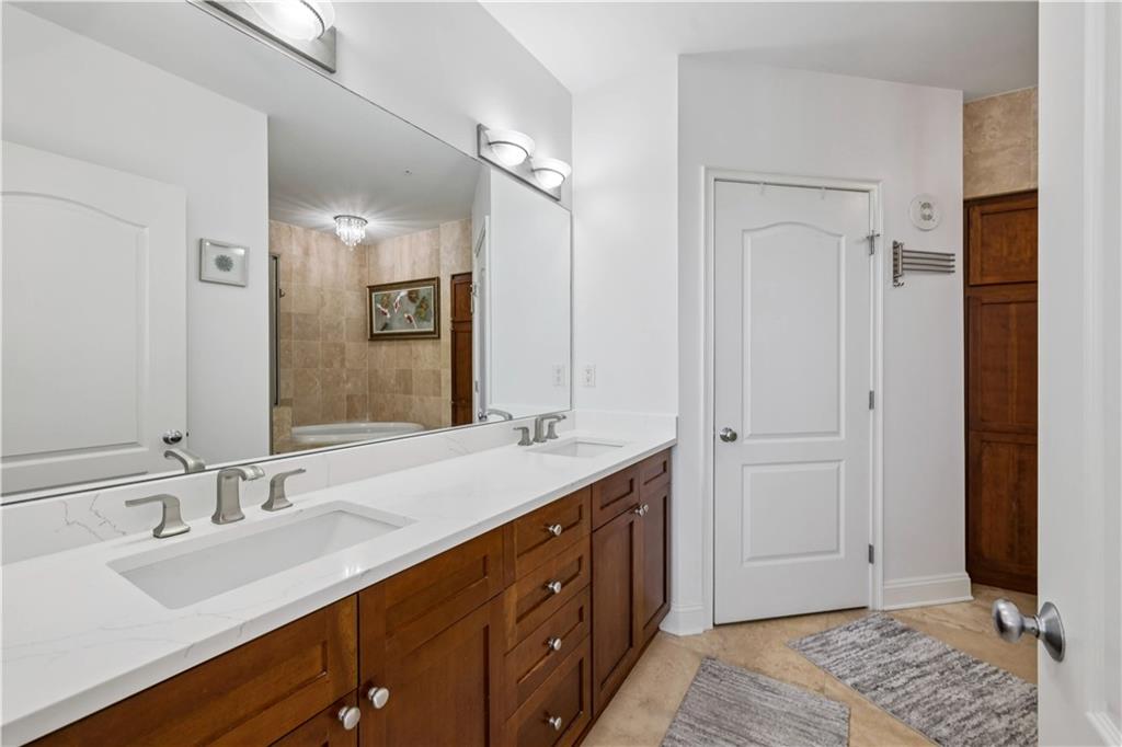 2828 Peachtree Road Northwest, Unit 2502 Atlanta, GA 30305 - Photo 18 of 38 a bathroom with a double vanity sink and a mirror