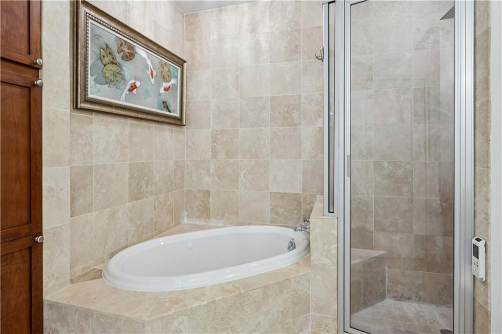 2828 Peachtree Road Northwest, Unit 2502 Atlanta, GA 30305 - Photo 19 of 38 a bathroom with a bathtub and shower