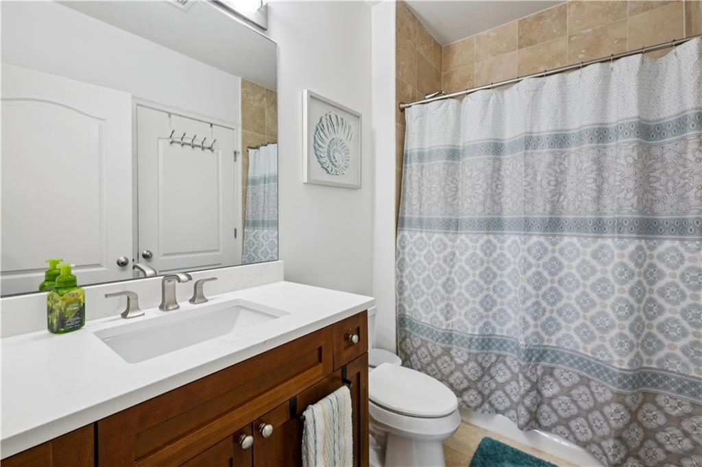 2828 Peachtree Road Northwest, Unit 2502 Atlanta, GA 30305 - Photo 6 of 38 a bathroom with a sink and a mirror