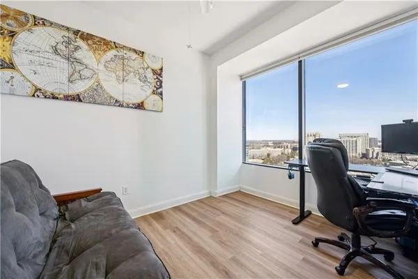 a view of a workspace with furniture and a window