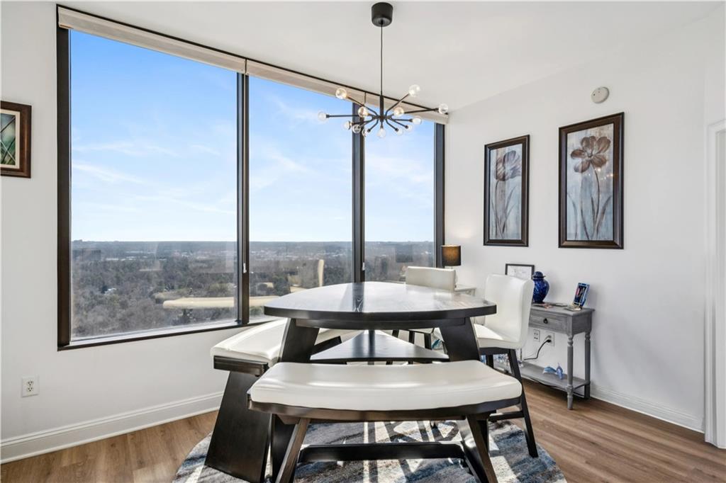 2828 Peachtree Road Northwest, Unit 2502 Atlanta, GA 30305 - Photo 10 of 38 a view of a dining room with furniture window and wooden floor