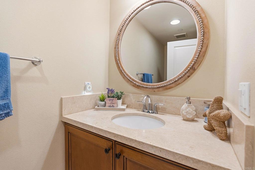 809 Dolphin Circle Encinitas, CA 92024 - Photo 19 of 71 a bathroom with a sink and a mirror
