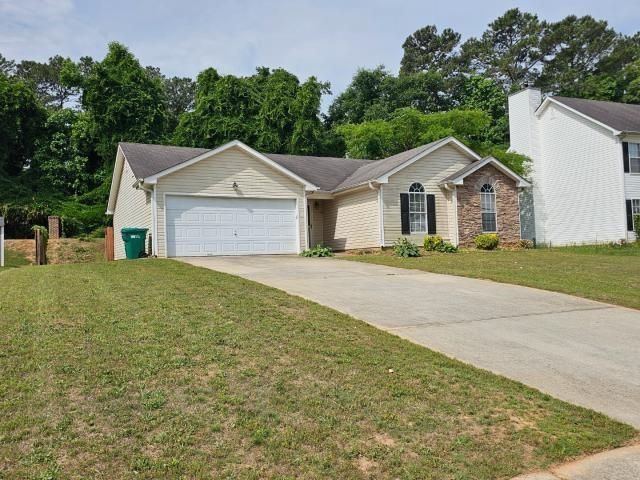 1443 Pebble Ridge Lane Hampton, GA 30228 - Photo 2 of 24 front view of a house with a yard
